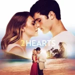 A couple stands close, eyes closed, under the word 2 Hearts. Below, a smaller image shows them embracing on a beach at sunset.