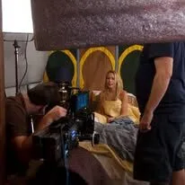 Filming a scene with a woman on set.